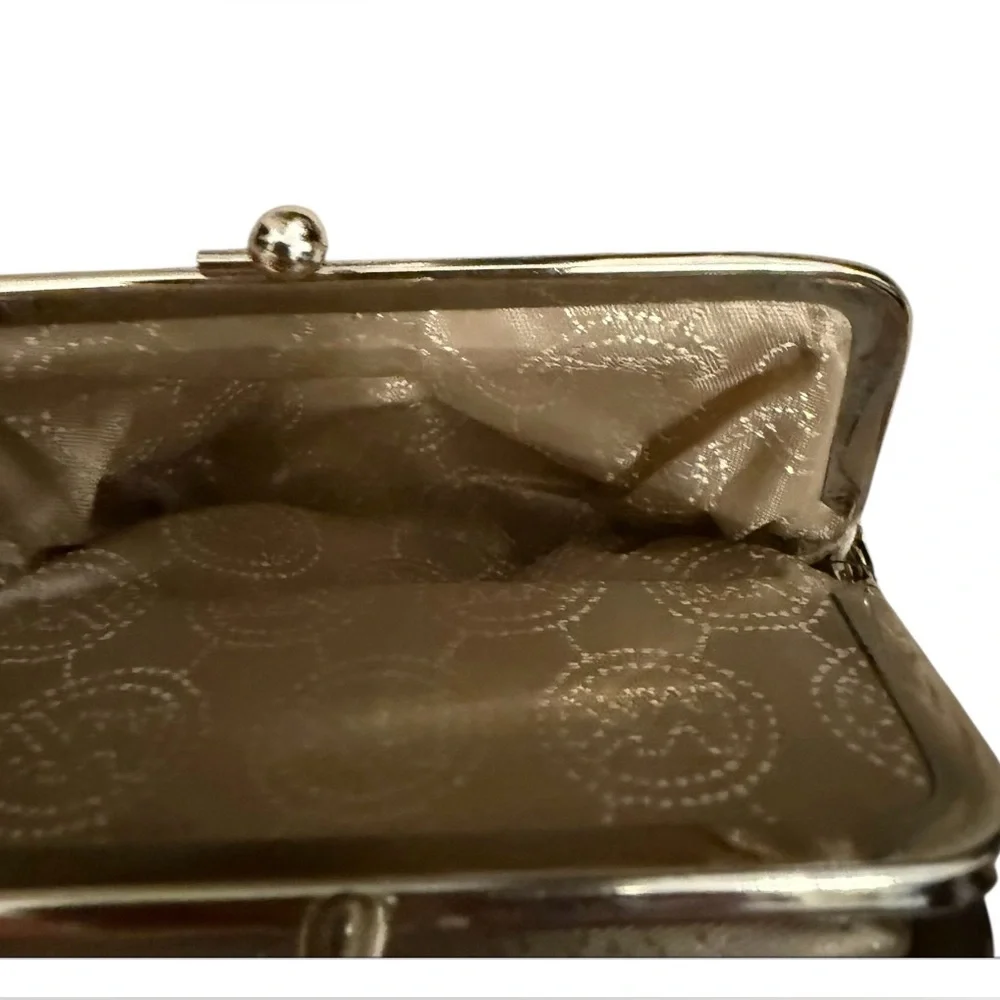 Michael Kors signature white and gray change purse with a clasp closure